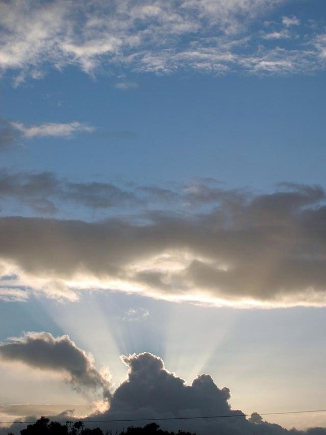 The sun coming through the clouds. 